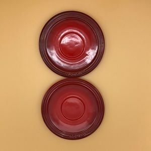 Two Red Le Creuset saucers